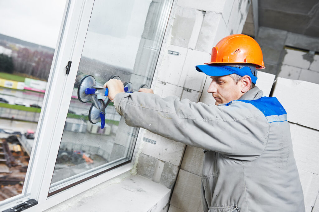 male,industrial,builder,worker,at,window,installation,in,building,construction male,industrial,builder,worker,at,window,installation,in,building,construction
